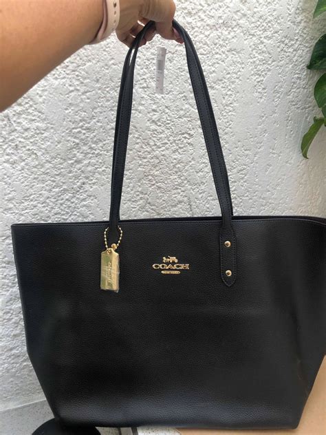 bolsa coach negra de mano